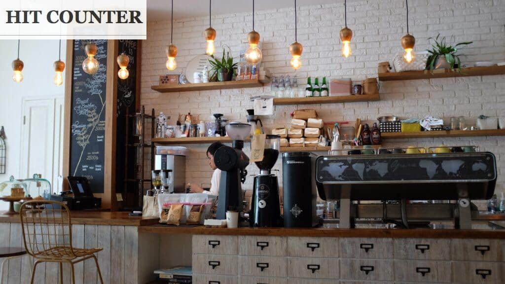 black kitchen appliance on kitchen island with pendant lights
