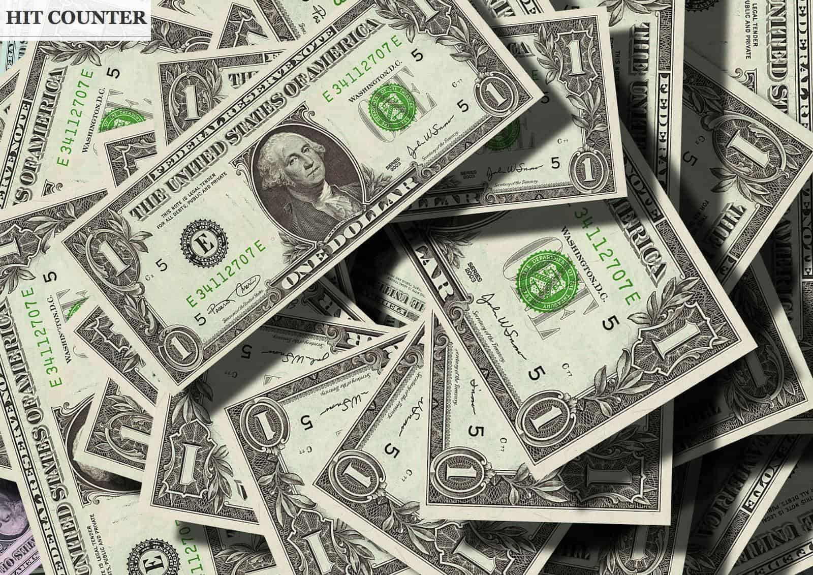 Close-up of scattered US dollar bills symbolizing finance and wealth.