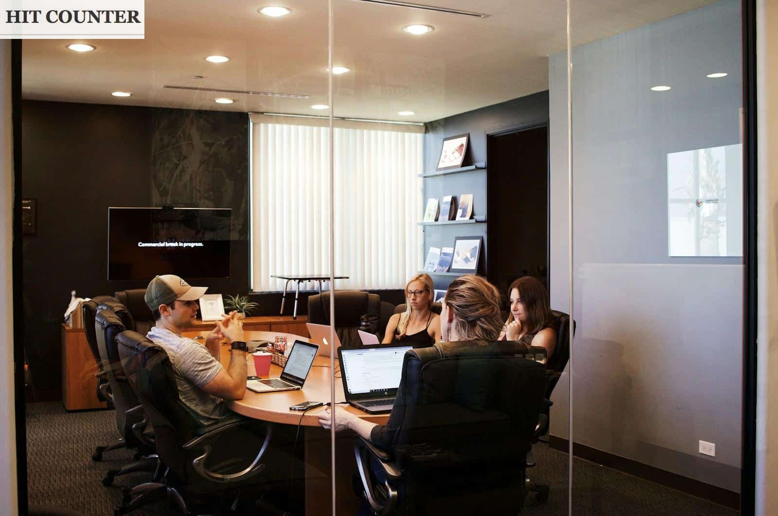 people sitting near table with laptop computer